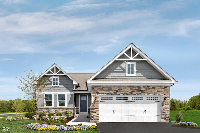 craftsman inspired home with an attached garage, driveway, a front lawn, and stone siding