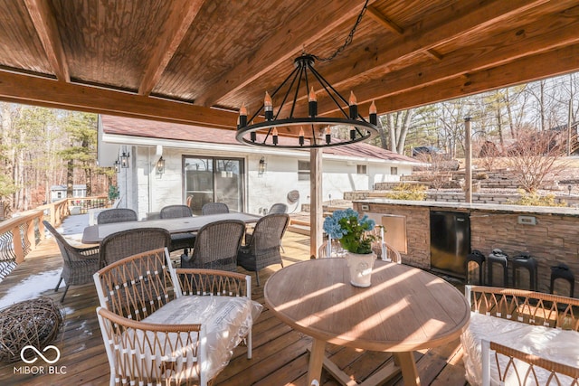 wooden deck featuring outdoor dining area and a gazebo