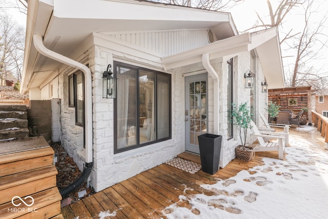 entrance to property featuring stone siding and fence