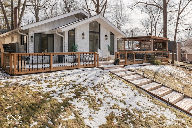 view of front of property with stone siding and a deck