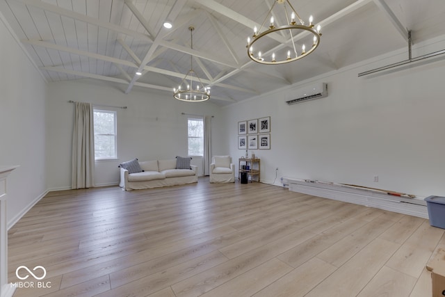 unfurnished room featuring light wood finished floors, baseboards, lofted ceiling with beams, an AC wall unit, and a chandelier