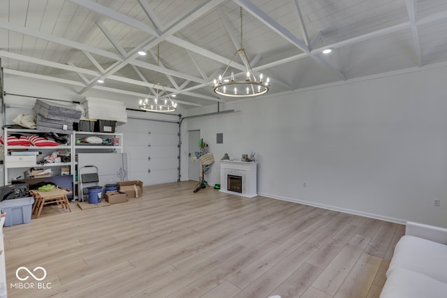 garage featuring wooden ceiling, a fireplace, and baseboards