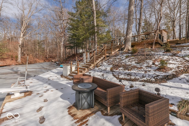 snow covered deck with stairs and a patio