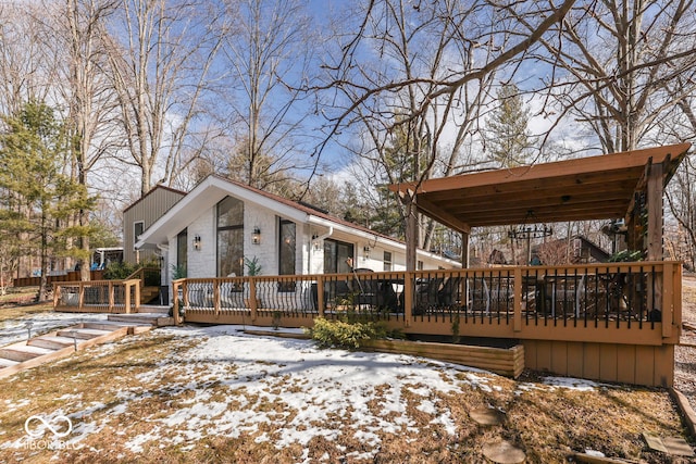 snow covered property featuring a deck