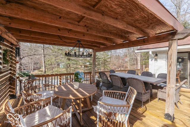 wooden terrace featuring outdoor dining area