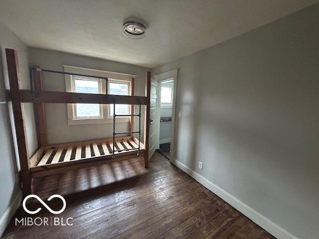 interior space featuring dark wood-style floors and baseboards