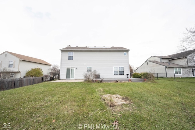 back of property featuring a yard, a fenced backyard, and a patio