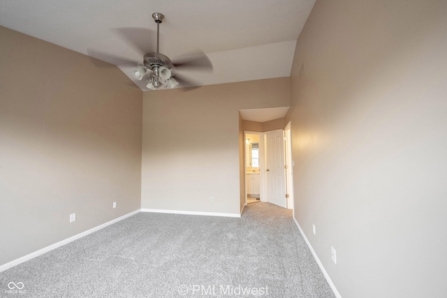 spare room with ceiling fan, light colored carpet, and baseboards