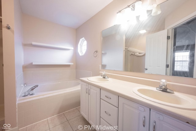 full bathroom with tile patterned flooring, a garden tub, a sink, and double vanity