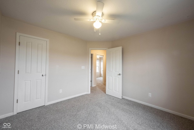 unfurnished bedroom featuring ceiling fan, carpet flooring, and baseboards