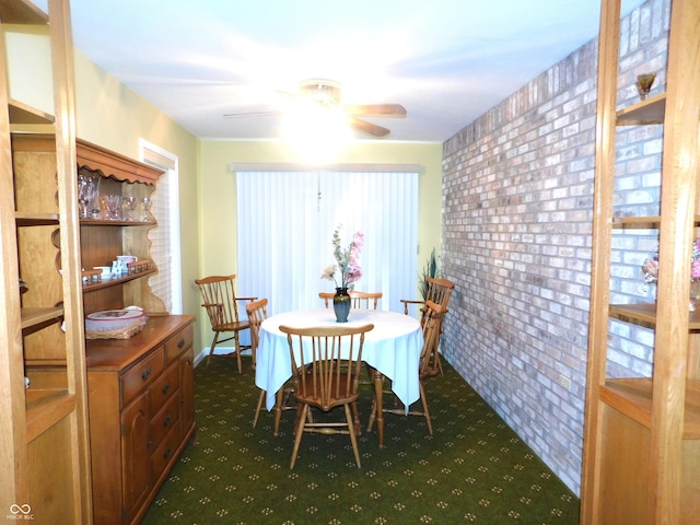 dining area with dark carpet and a ceiling fan