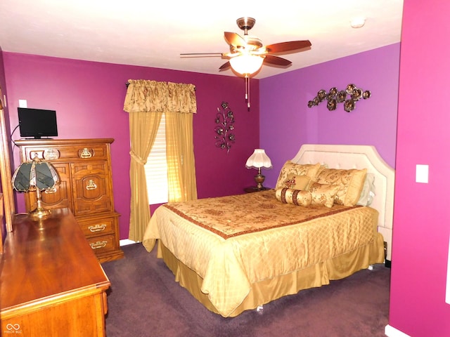 bedroom with dark colored carpet and a ceiling fan