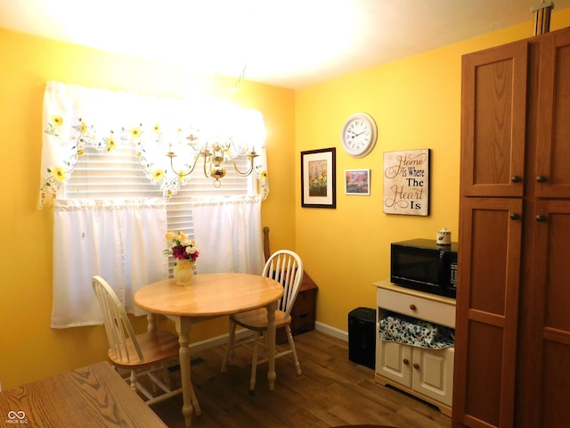 dining room with dark wood-style floors and baseboards