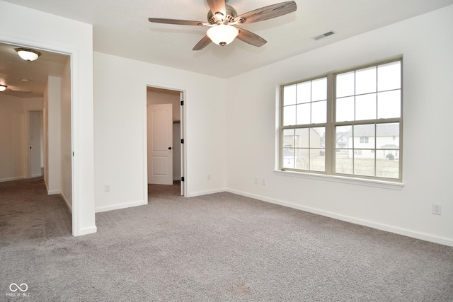 unfurnished bedroom with carpet, visible vents, ceiling fan, and baseboards