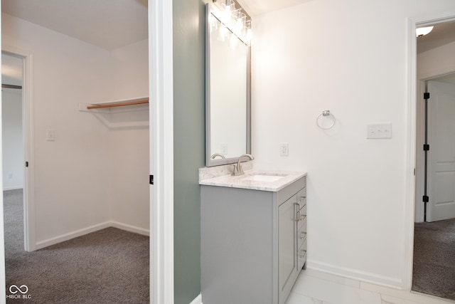 bathroom featuring baseboards and vanity