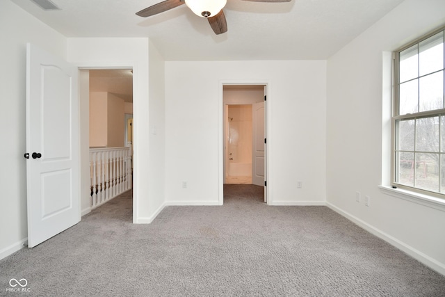 unfurnished bedroom with visible vents, carpet flooring, ceiling fan, ensuite bath, and baseboards