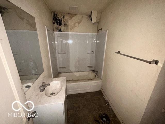 bathroom featuring  shower combination and vanity