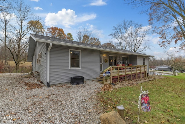 view of front of home featuring a deck and a front lawn