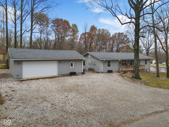 view of front of property featuring a garage, an outdoor structure, and a porch