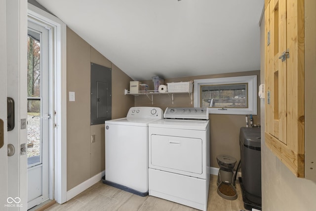 washroom featuring baseboards, laundry area, electric panel, and washer and dryer