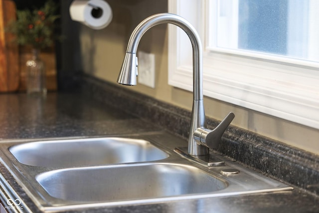 interior details featuring dark countertops and a sink