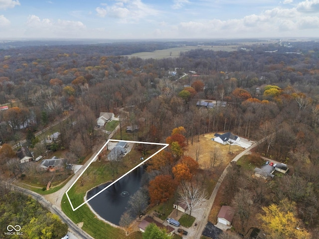 drone / aerial view with a water view and a wooded view