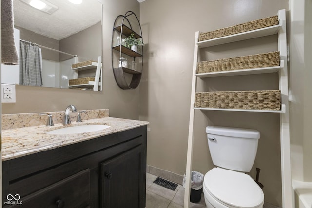 bathroom with visible vents, a shower with shower curtain, toilet, vanity, and tile patterned flooring