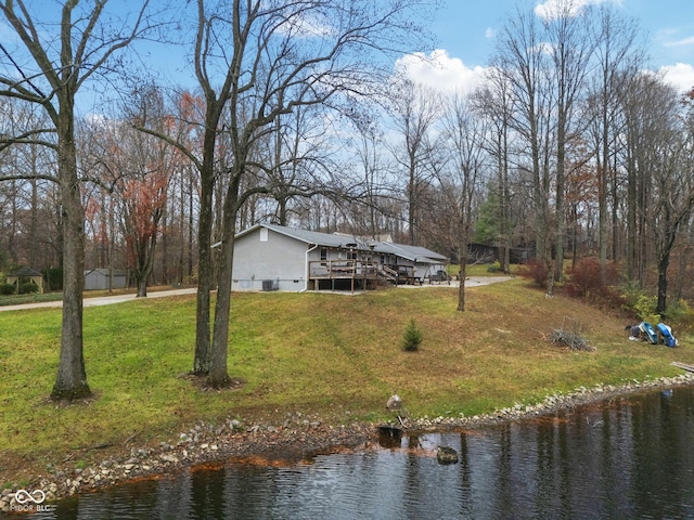 exterior space with a water view, crawl space, and a front lawn