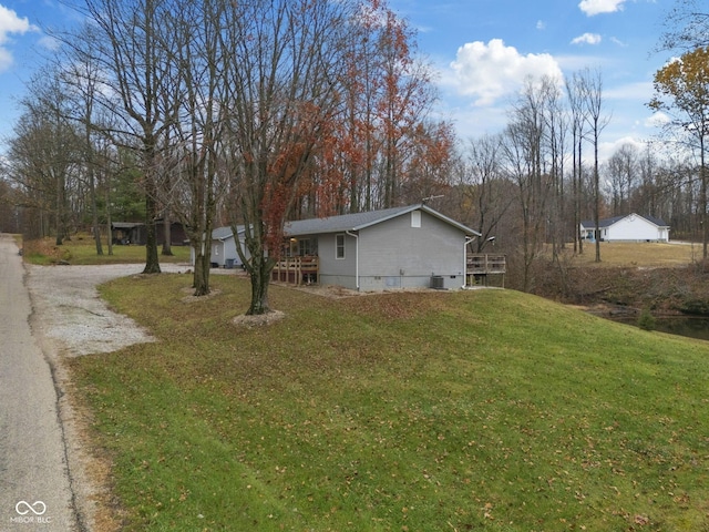 view of property exterior with a lawn and driveway