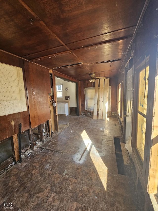 miscellaneous room featuring wood walls