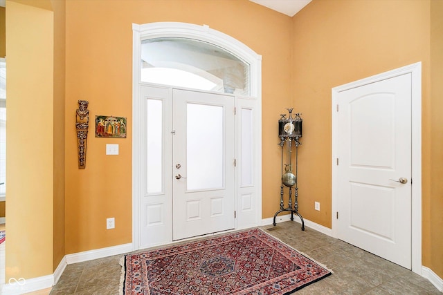 tiled foyer entrance with baseboards