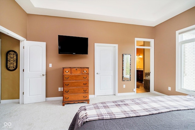 bedroom featuring carpet, multiple windows, connected bathroom, and baseboards