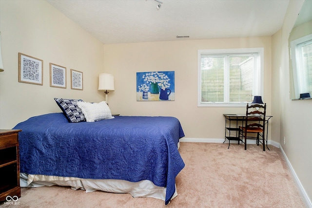 carpeted bedroom with baseboards, multiple windows, and visible vents