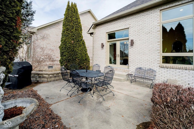 view of patio / terrace featuring outdoor dining area, area for grilling, and french doors