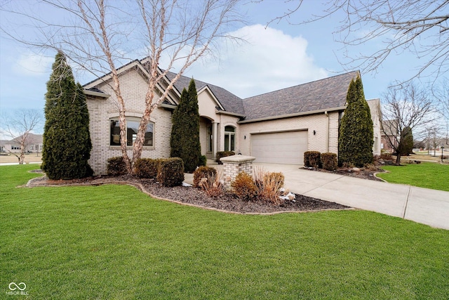 french country inspired facade featuring a shingled roof, concrete driveway, an attached garage, a front lawn, and brick siding