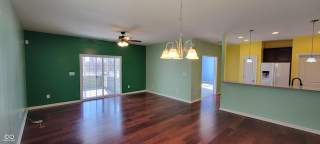 unfurnished room with baseboards, dark wood finished floors, a sink, and recessed lighting