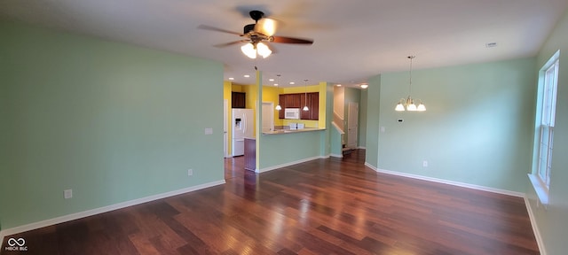 unfurnished living room featuring recessed lighting, dark wood finished floors, baseboards, and ceiling fan with notable chandelier