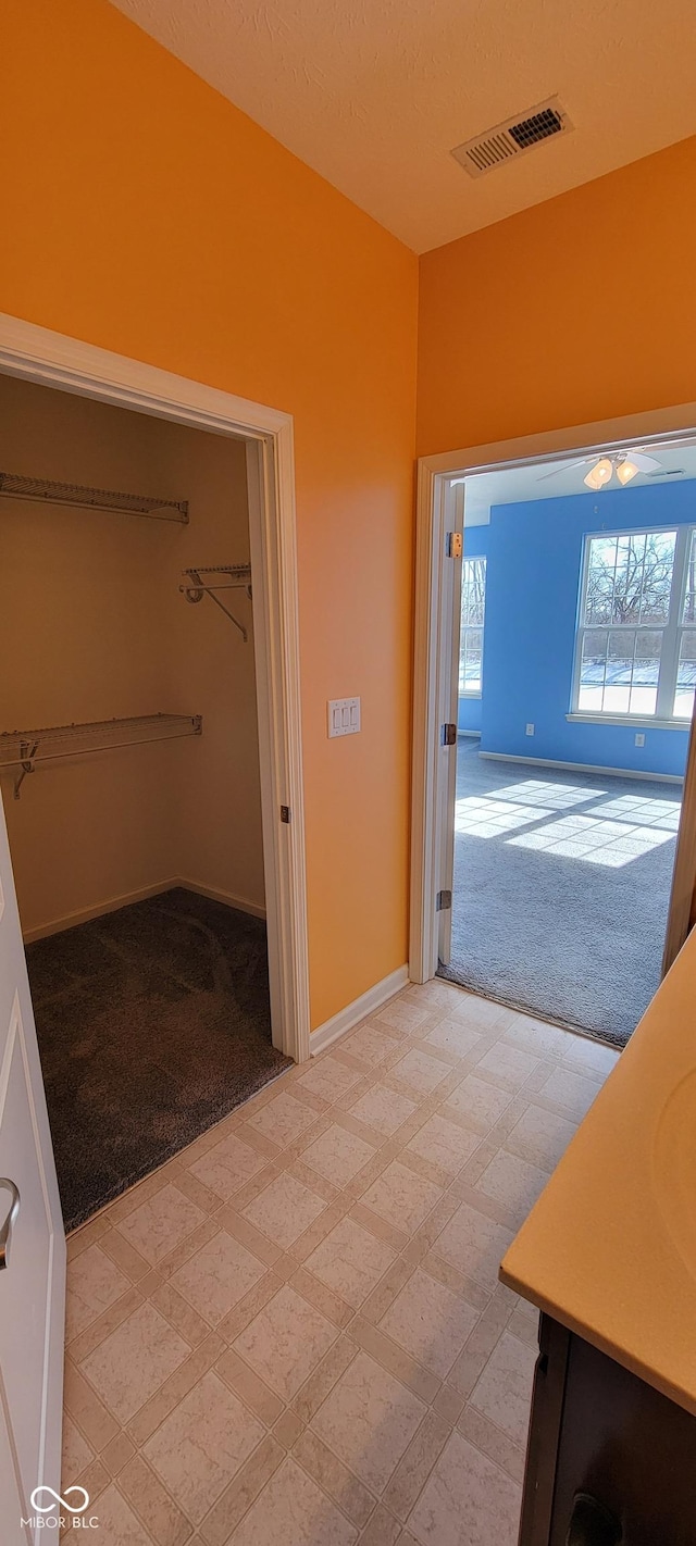 interior space featuring baseboards, vanity, visible vents, and tile patterned floors