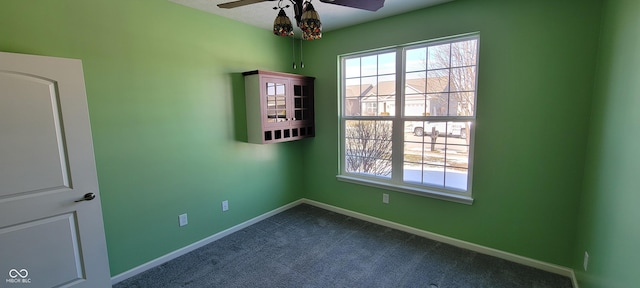 unfurnished room featuring carpet floors, plenty of natural light, and baseboards