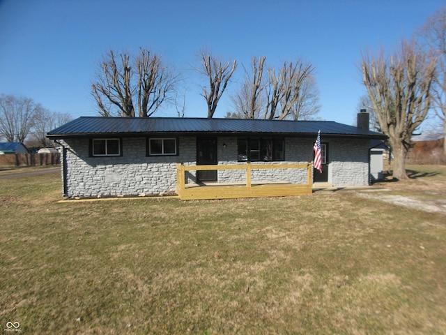 single story home with metal roof, a chimney, and a front lawn