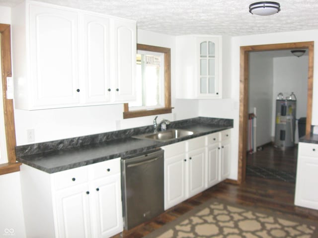 kitchen with glass insert cabinets, dark countertops, white cabinetry, and stainless steel dishwasher