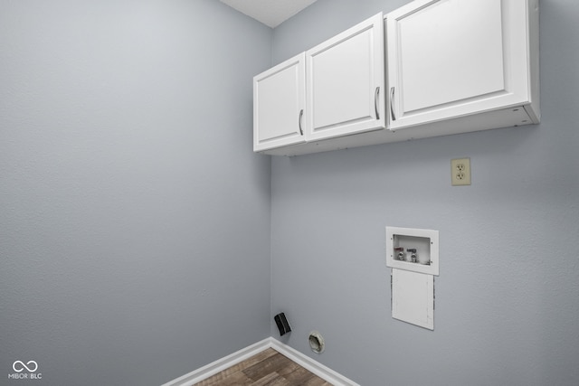 laundry room with hookup for a washing machine, dark wood-style flooring, cabinet space, and baseboards