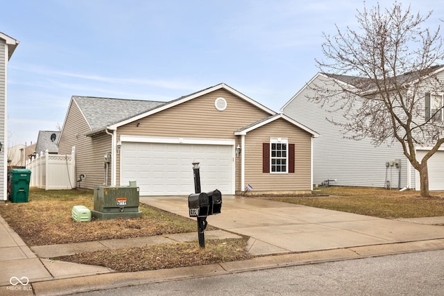 view of front of property with concrete driveway, a shingled roof, an attached garage, and fence