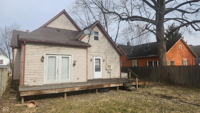 rear view of property featuring french doors, fence, and a wooden deck