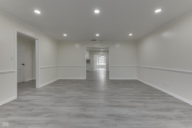 spare room featuring light wood-type flooring, ornamental molding, and recessed lighting