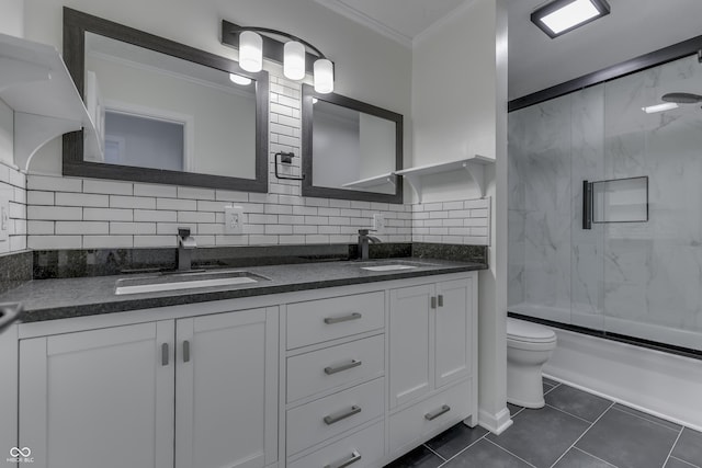 bathroom featuring ornamental molding, backsplash, a sink, and tile patterned floors