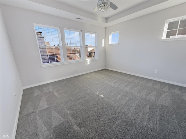 spare room featuring visible vents, baseboards, and carpet flooring