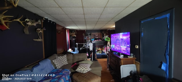 living room featuring a paneled ceiling