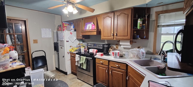 kitchen with brown cabinets, stainless steel electric stove, white refrigerator with ice dispenser, and light countertops