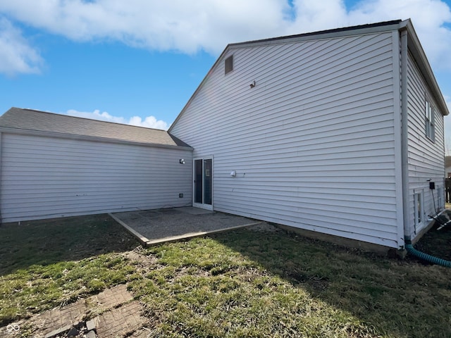 rear view of house featuring a yard and a patio